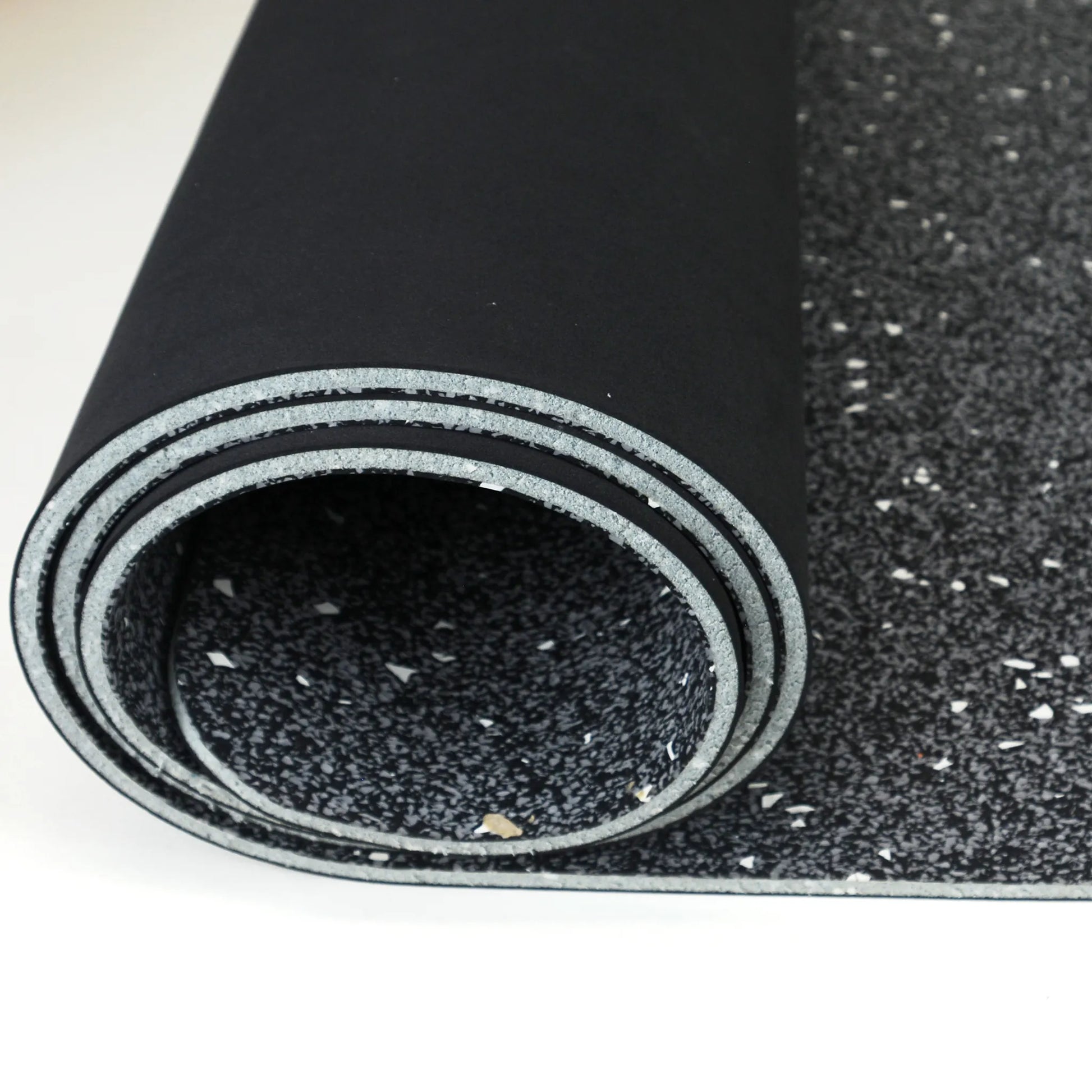 Black yoga mat rolled up.