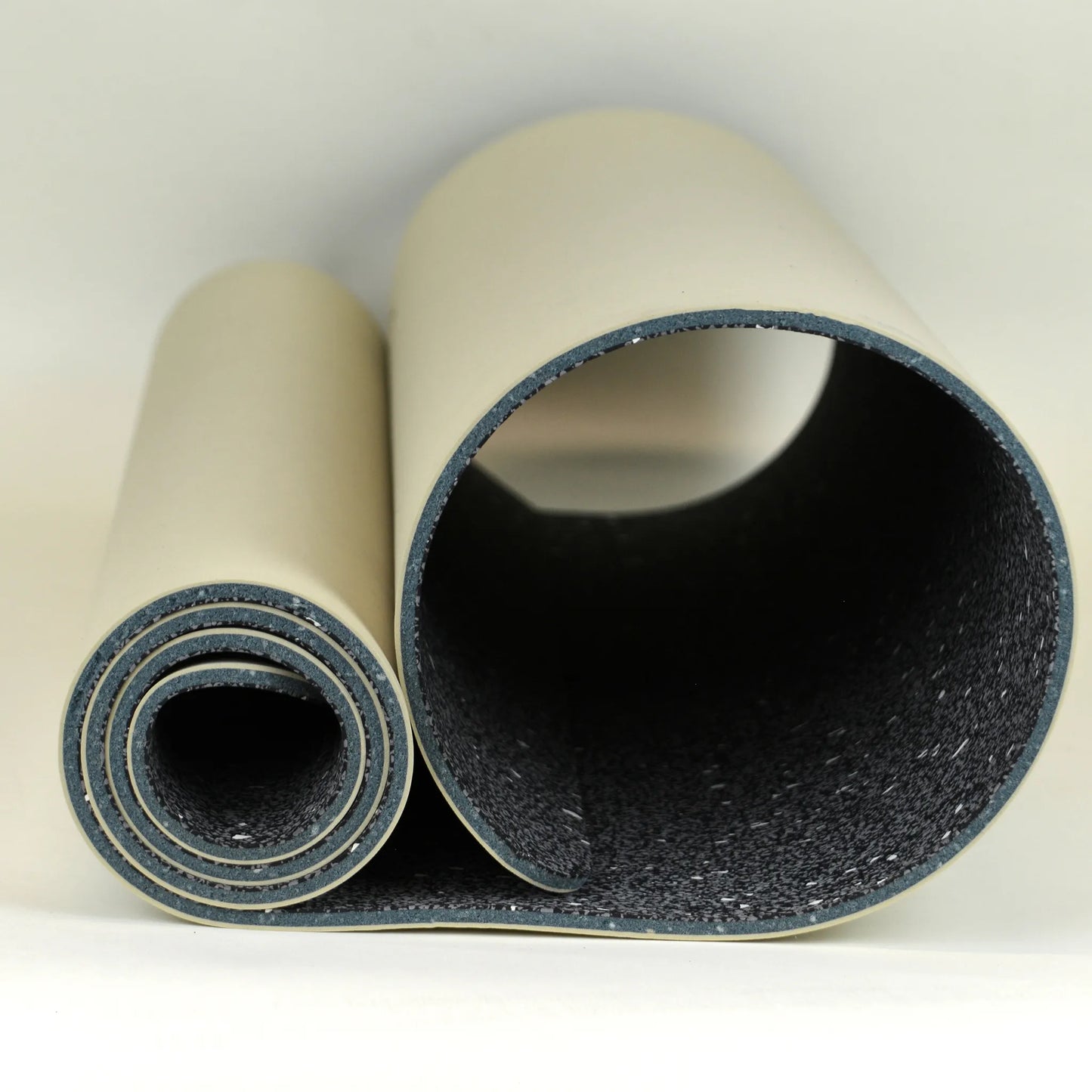 Tan yoga mat rolled up.