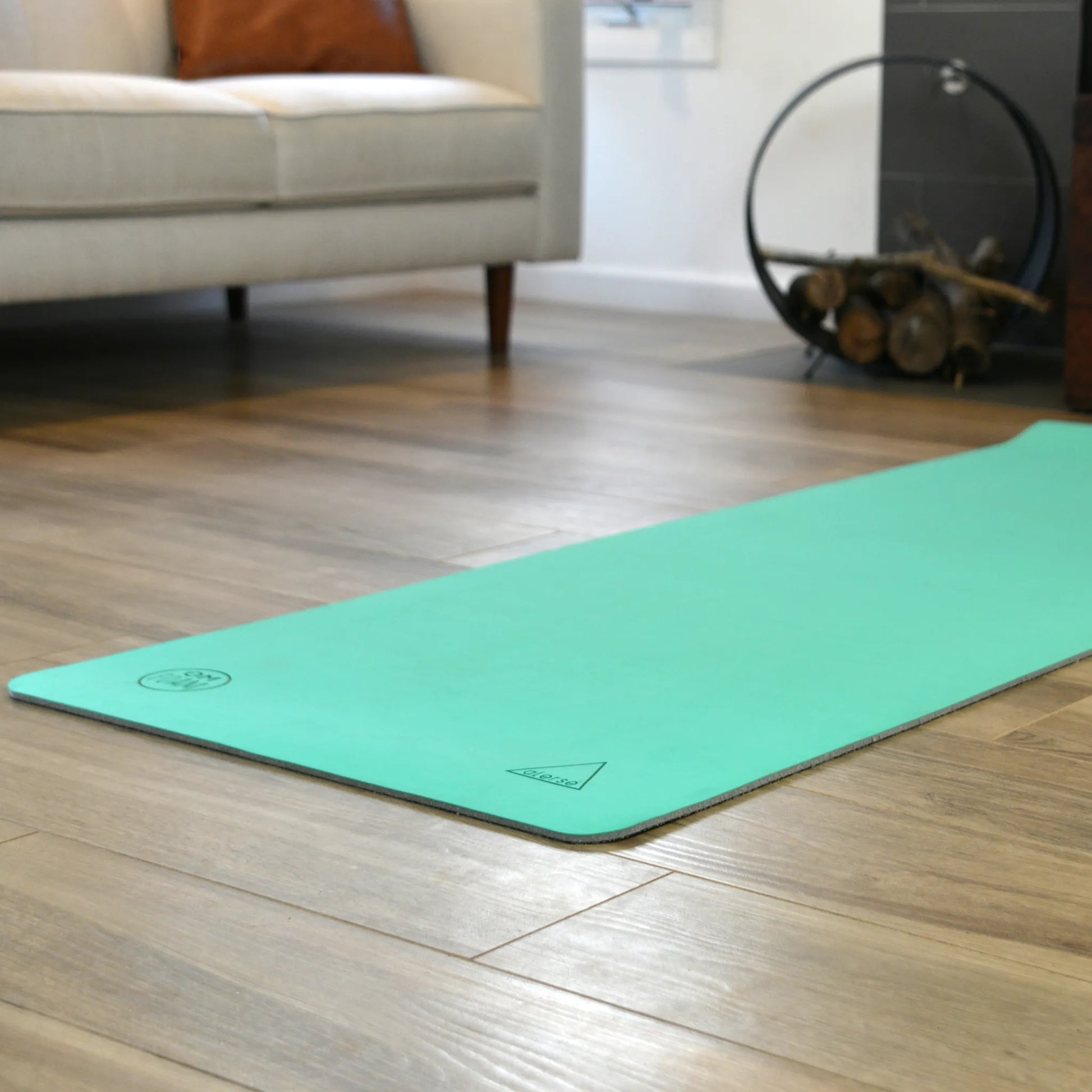Teal yoga mat lying flat on the floor.