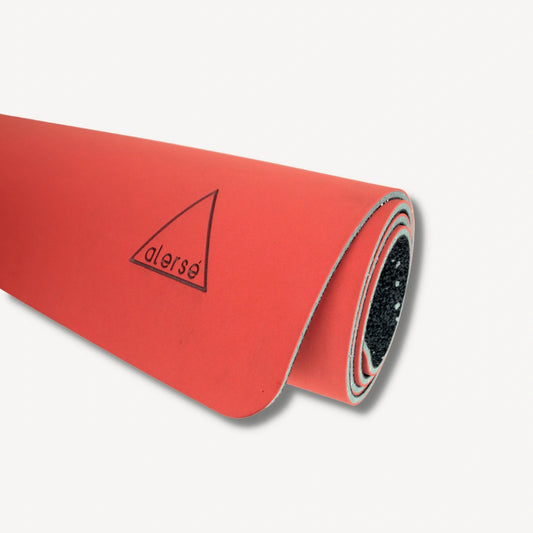 Red yoga mat rolled up with a Alerse logo on it.