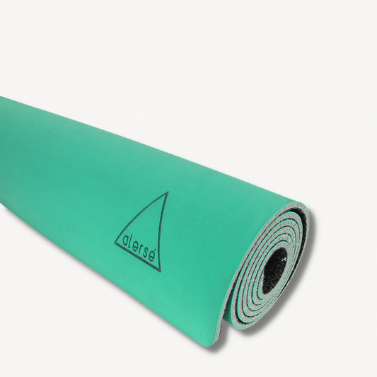 Teal yoga mat with a Alerse logo on it.