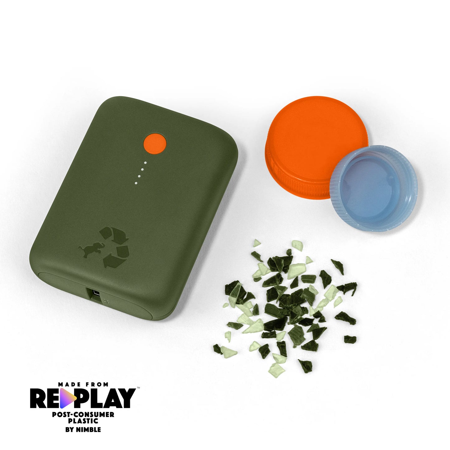 Green portable charger with orange button next to bottle caps and shredded plastic.
