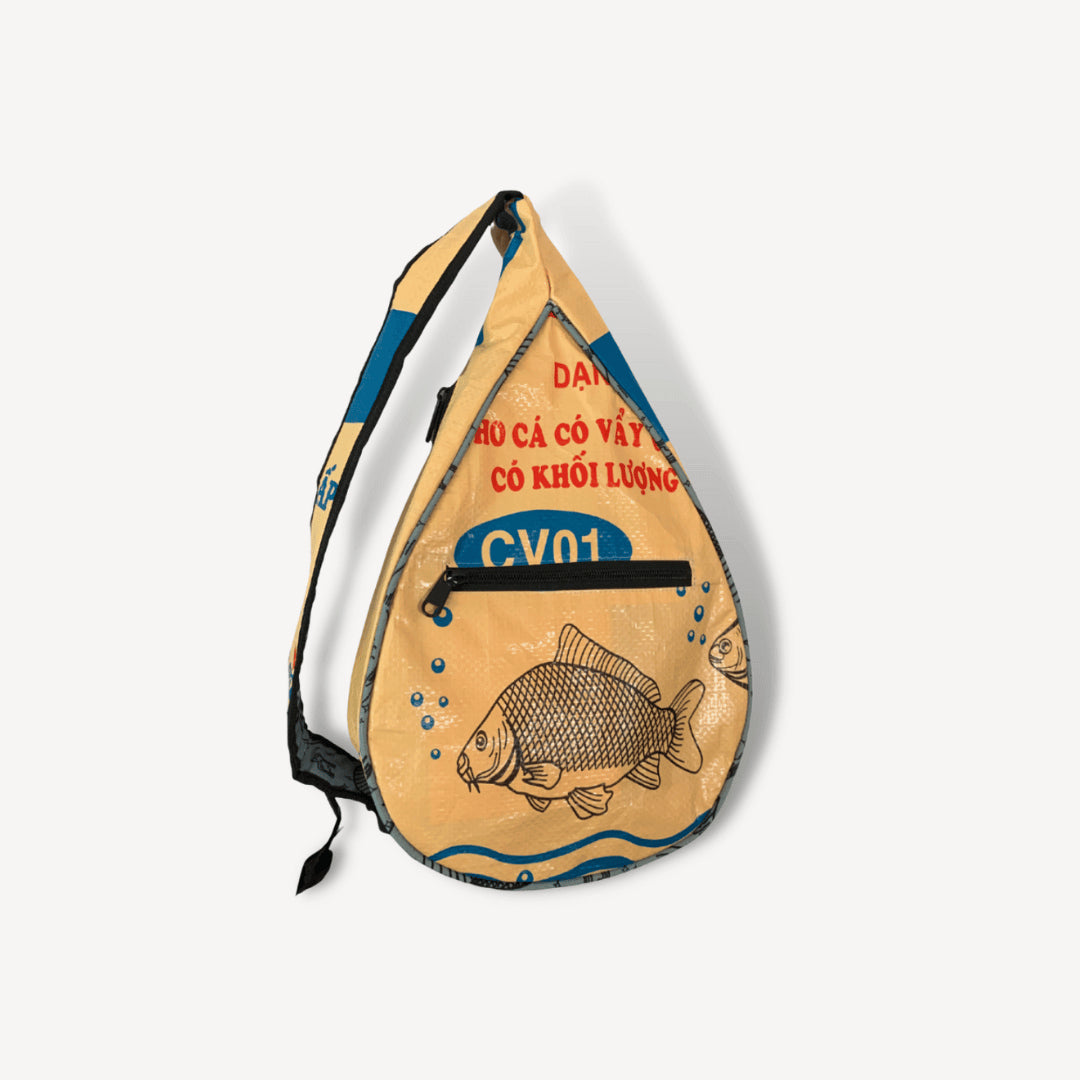 Tan sling bag with a fish on it.