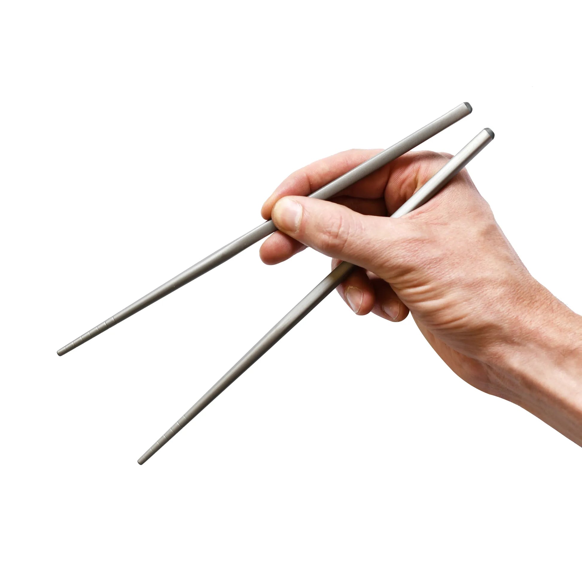 Hand holding titanium chopsticks.