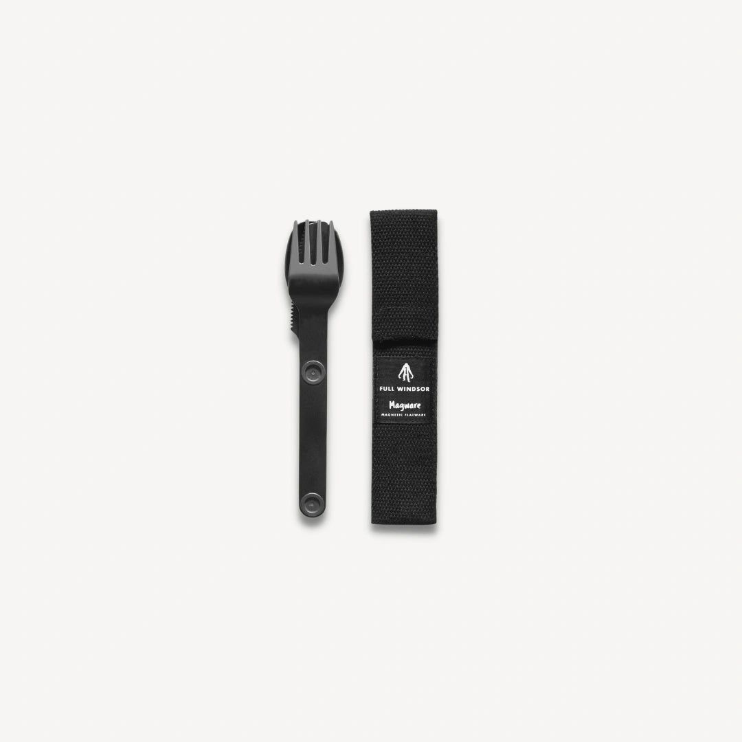 Black spoon, fork and knife connected next to black case.