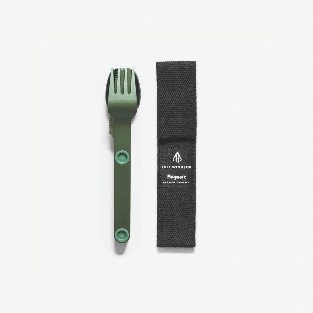 Green fork, knife and spoon connected next to black case.