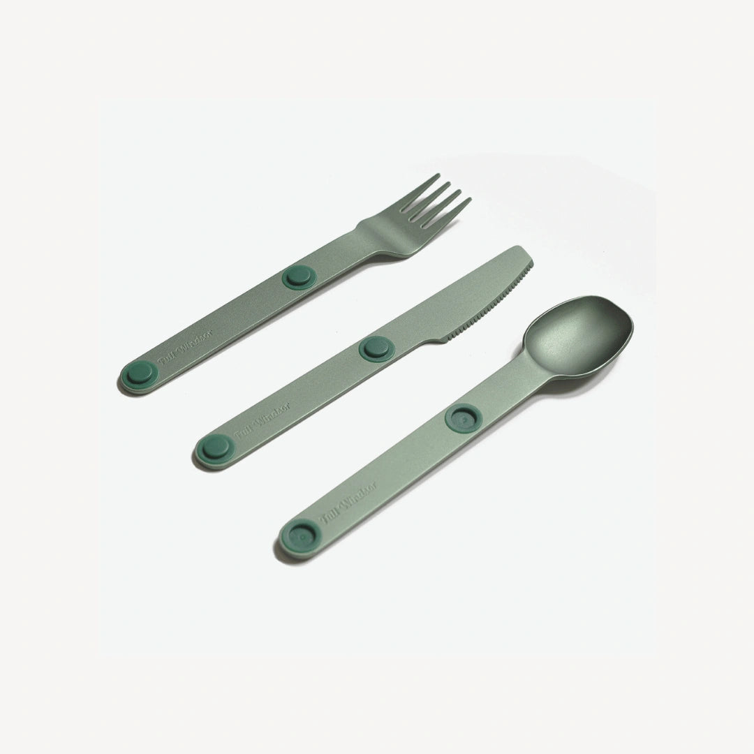 Green fork, knife and spoon angled.
