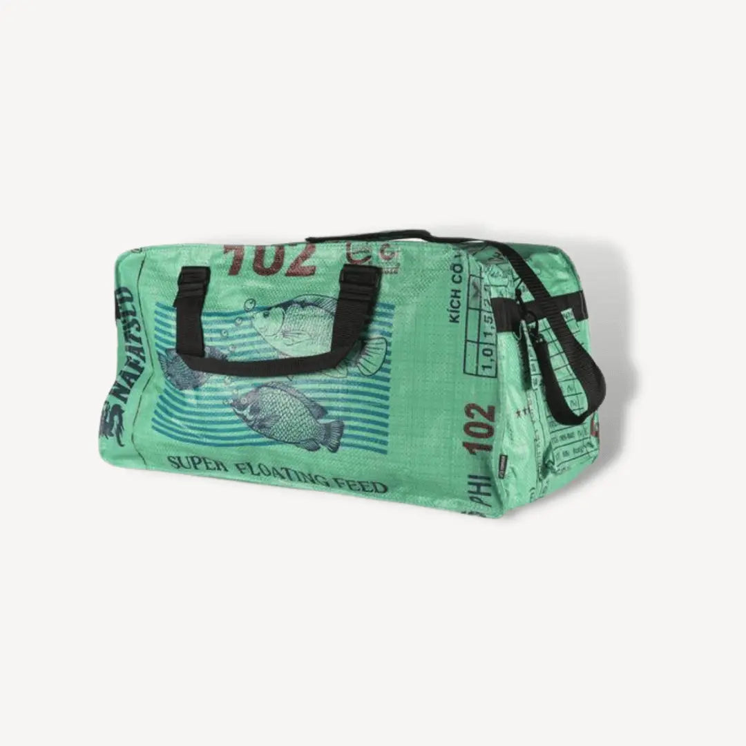 Green duffel bag with fish on it.