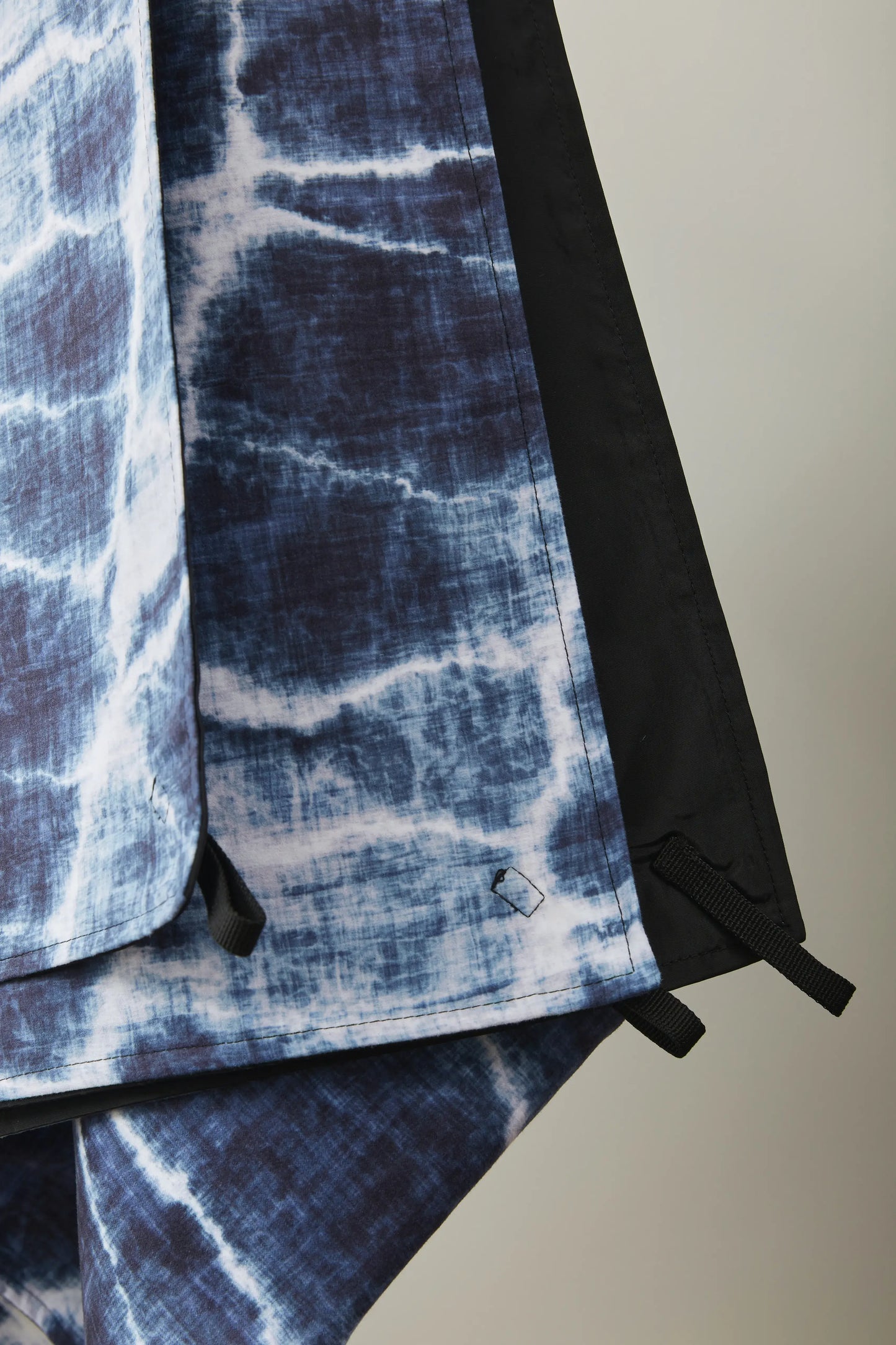 Closeup of a blue and white blanket hanging.