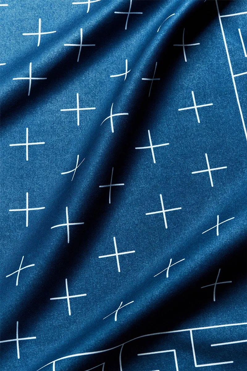 Close up of a blue bandana with white cross markings.