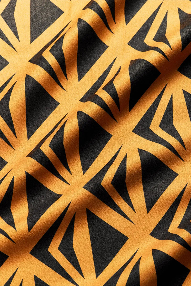 Close up of yellow bandana with black triangle markings.