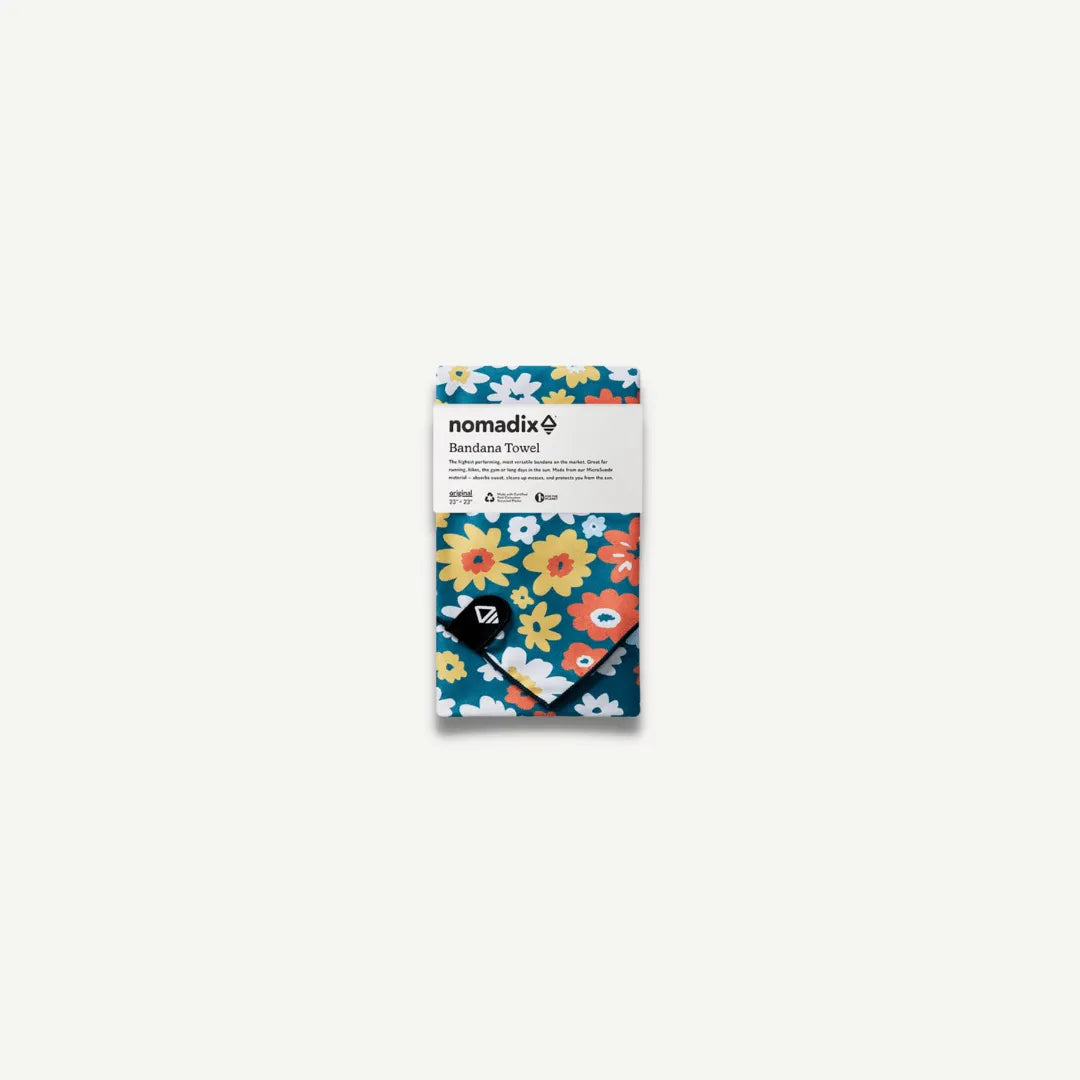 Nomadix bandana with white, yellow and orange flowers in package.