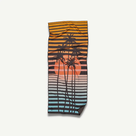 Beach towel with a sunset and palm trees on it.