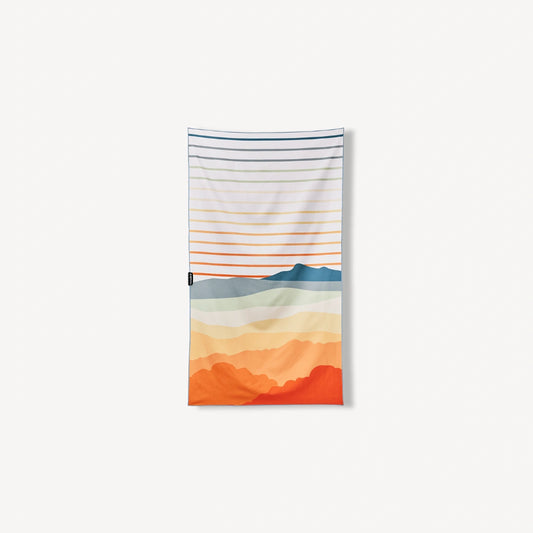 White towel with multi-colored lines and hills.