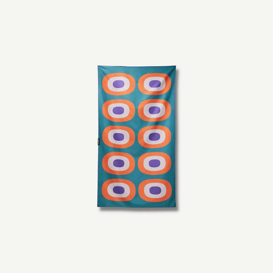 Teal towel with orange, white and purple circles.