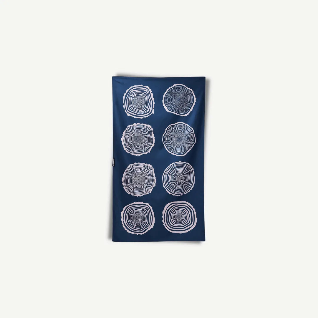 Navy blue towel with white tree ring circles.