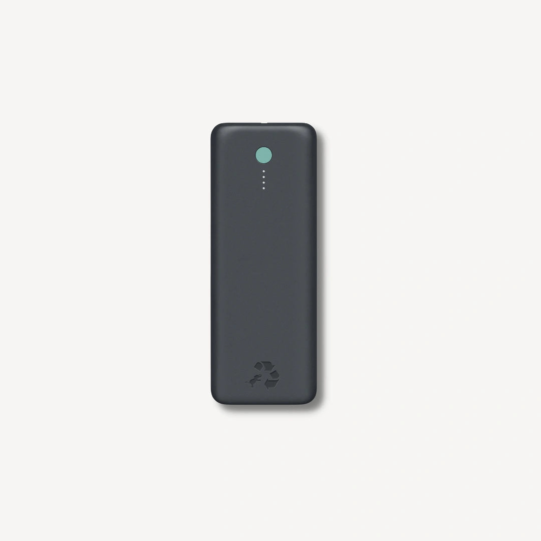 Large dark gray portable charger with green button.
