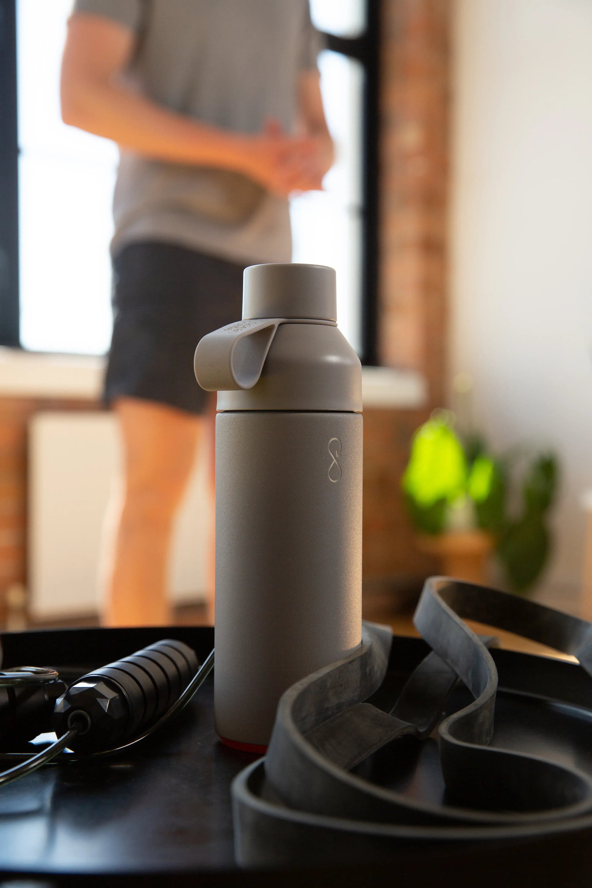 Man exercising with a gray water bottle.