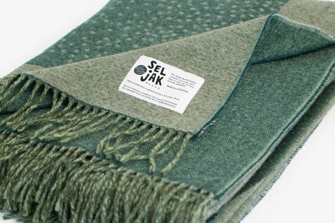 Corner folded over on a green wool blanket.