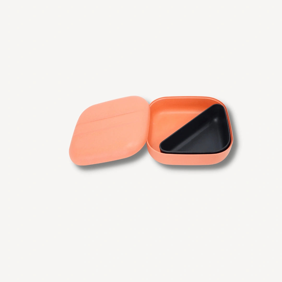 Coral bento box with black insert.