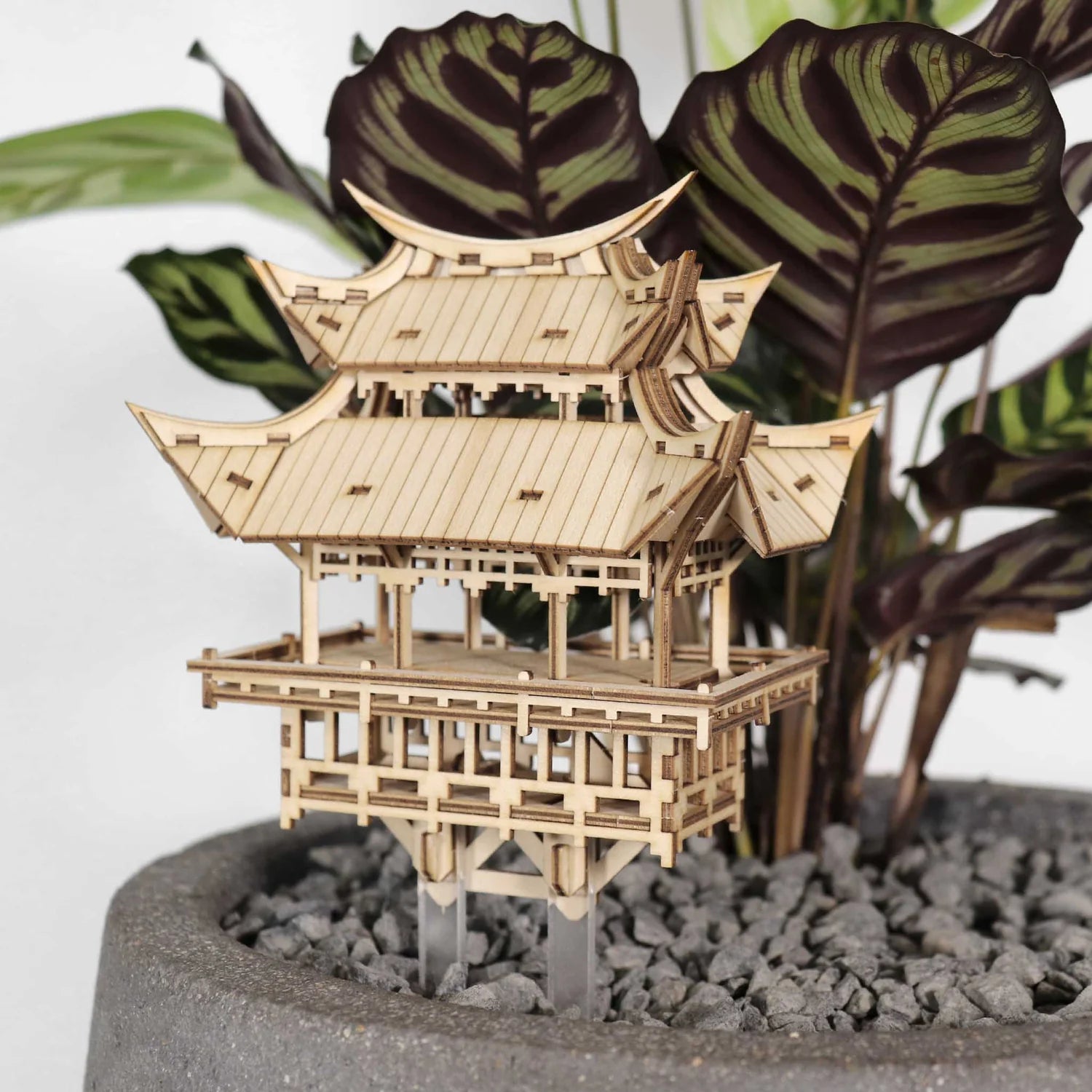 Wooden treehouse model in potted plant
