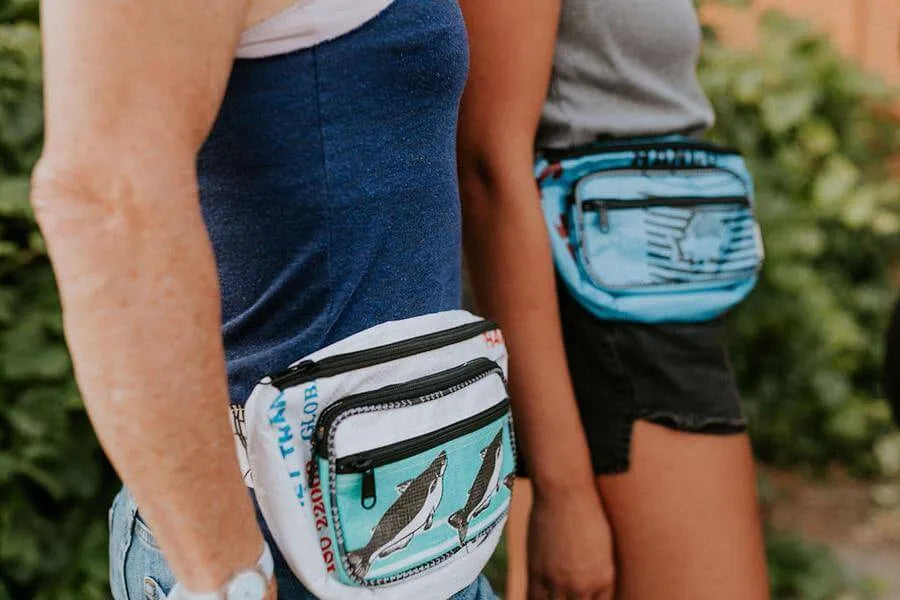 Two people outside wearing hip bags.