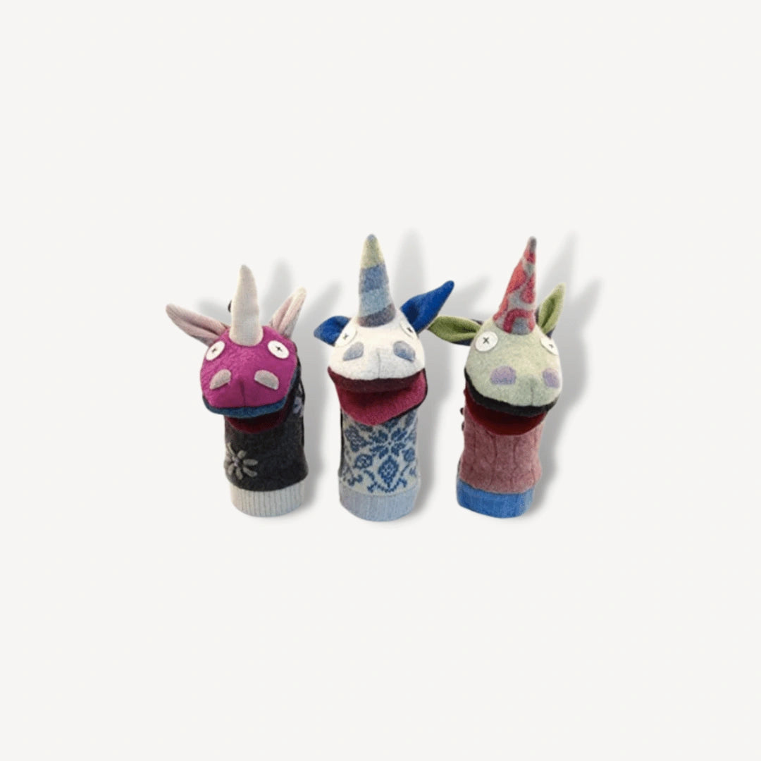 Three unicorn hand puppets of different colors.