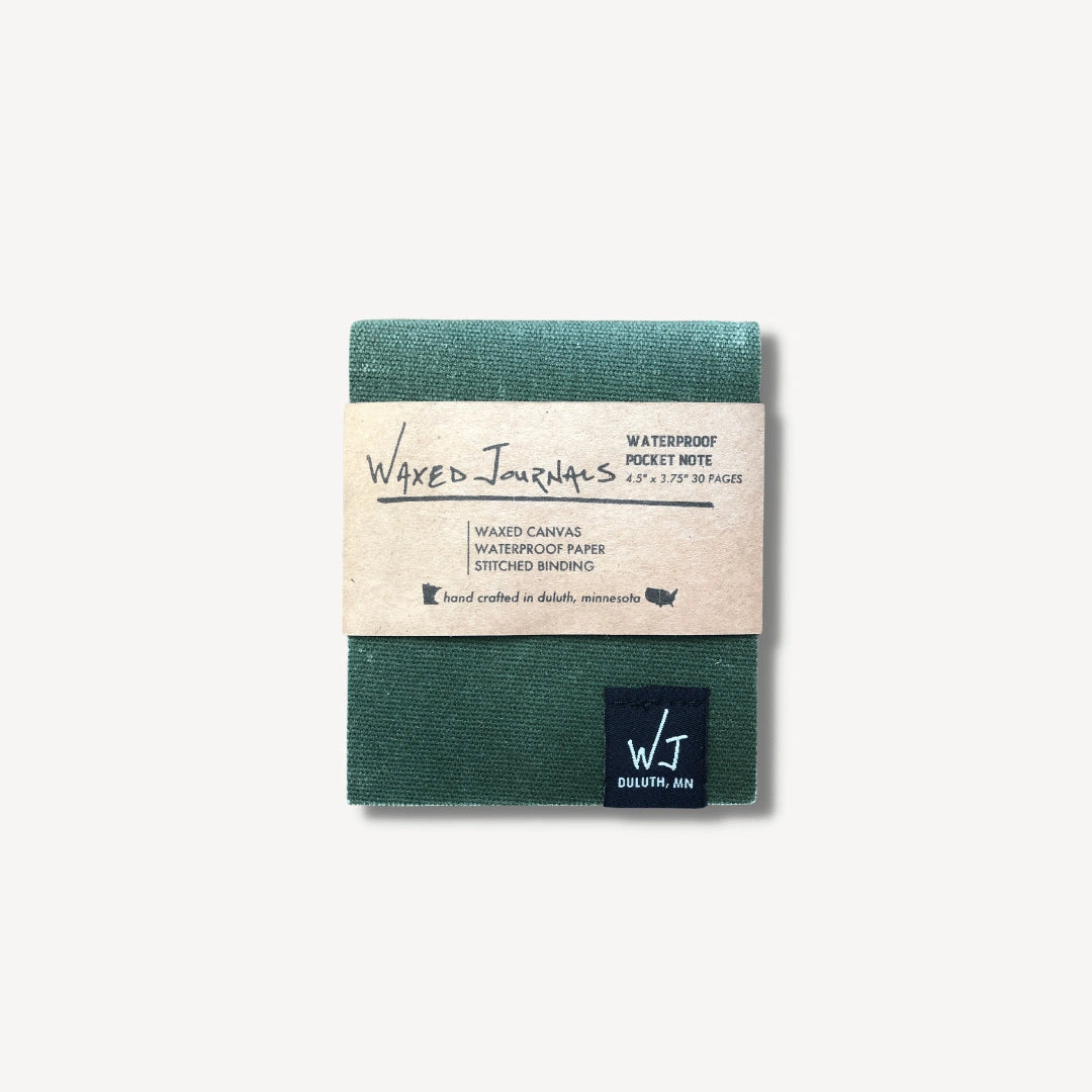 Green waxed journal notepad in packaging.