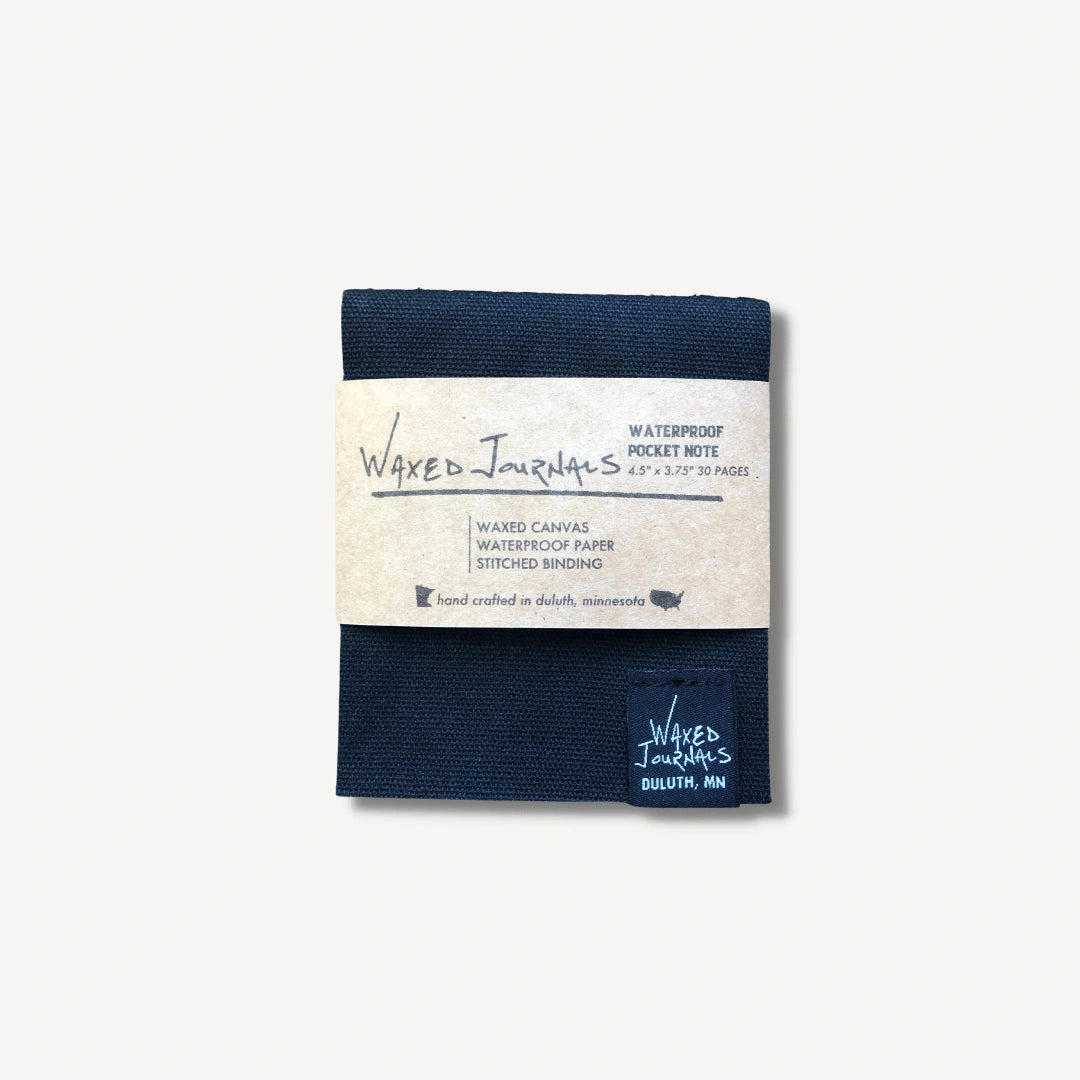 Black waxed journal notepad in packaging.