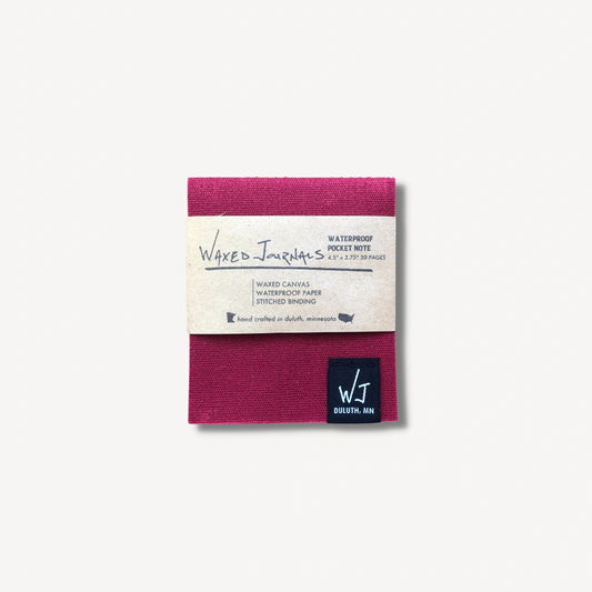 Red waxed journal notepad in packaging.