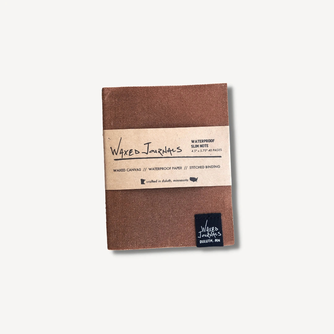 Brown waxed journal notebook in packaging.