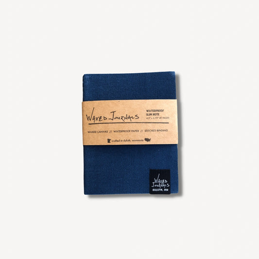 Blue waxed journal notebook in packaging.