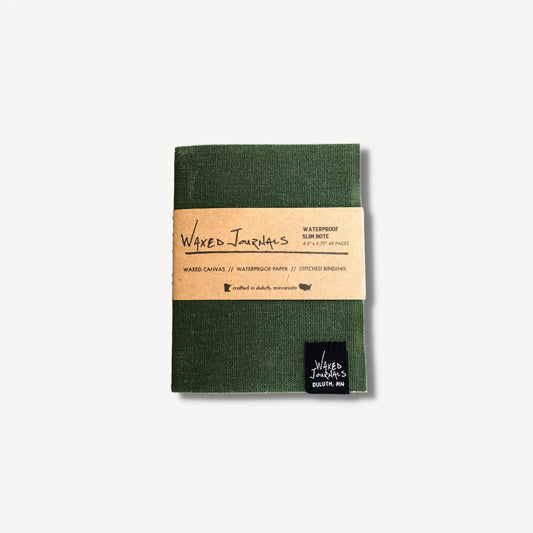 Green waxed journal notebook in packaging.