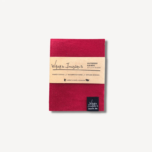 Red waxed journal notebook in packaging.