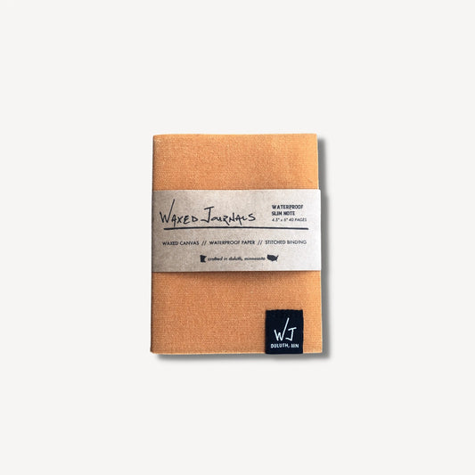 Yellow waxed journal notebook in packaging.