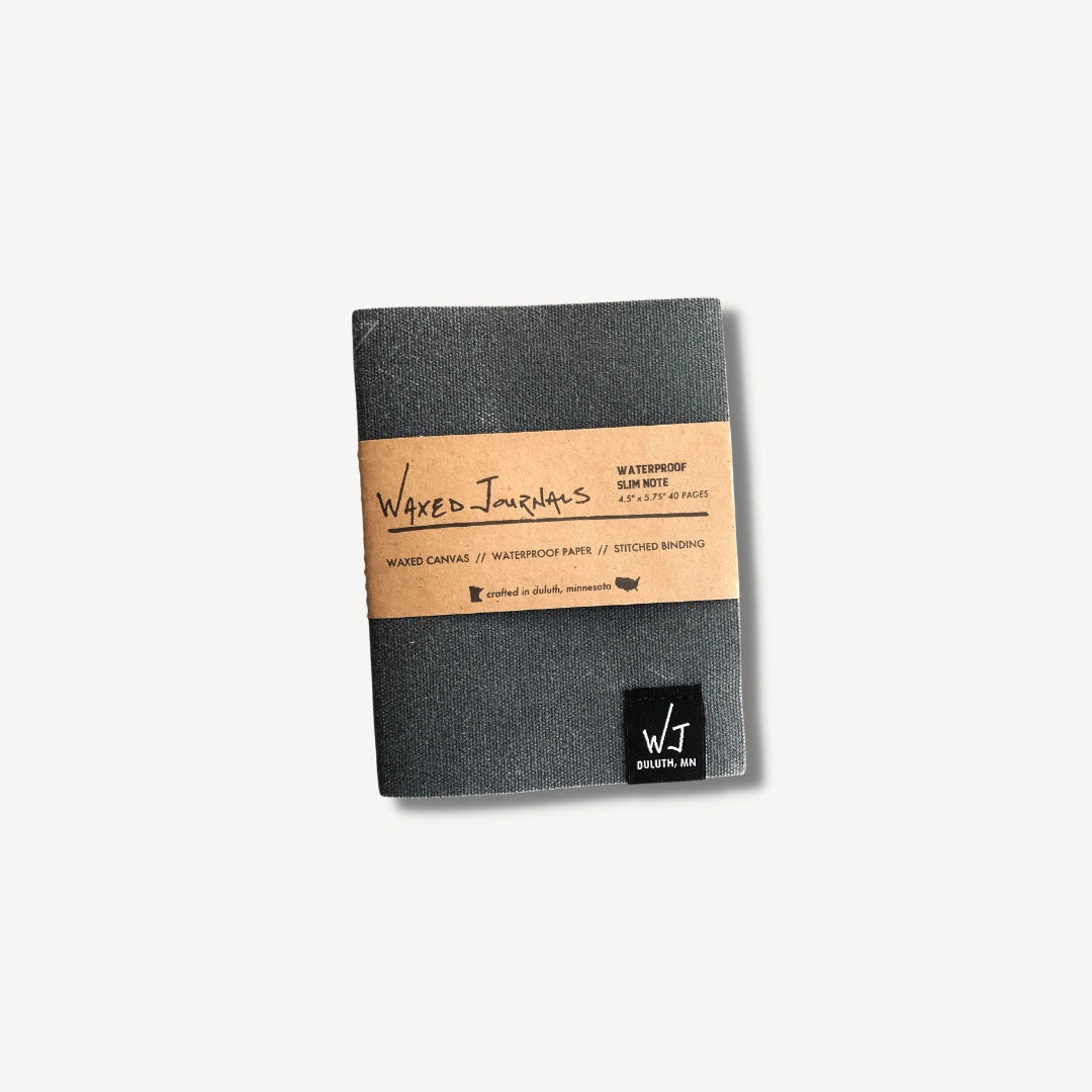 Gray waxed journal notebook in packaging.
