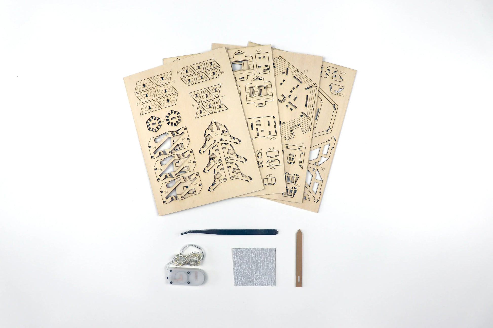 Pieces of a small wooden treehouse kit.