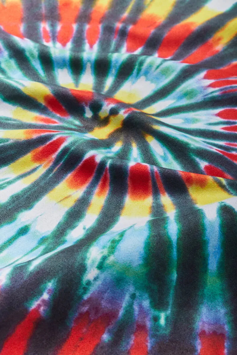 Close up of bandana with red, blue, yellow and white tie-dye.