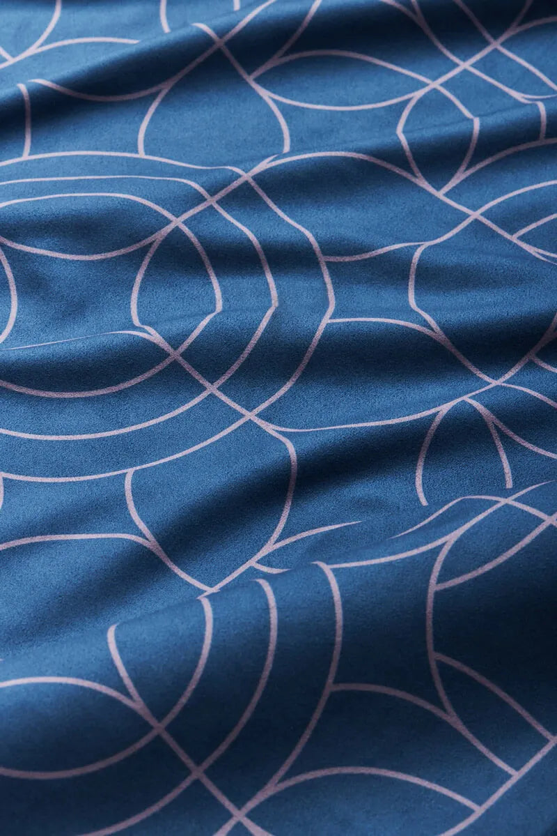 Close up of blue bandana with white circles.