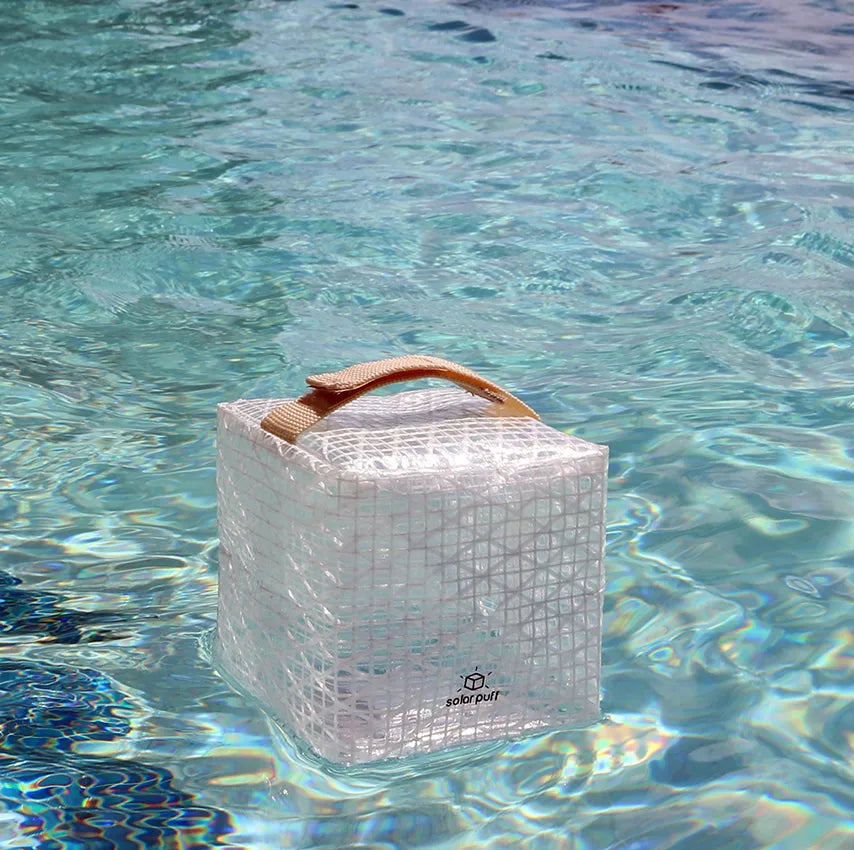 Cube lantern floating in water.